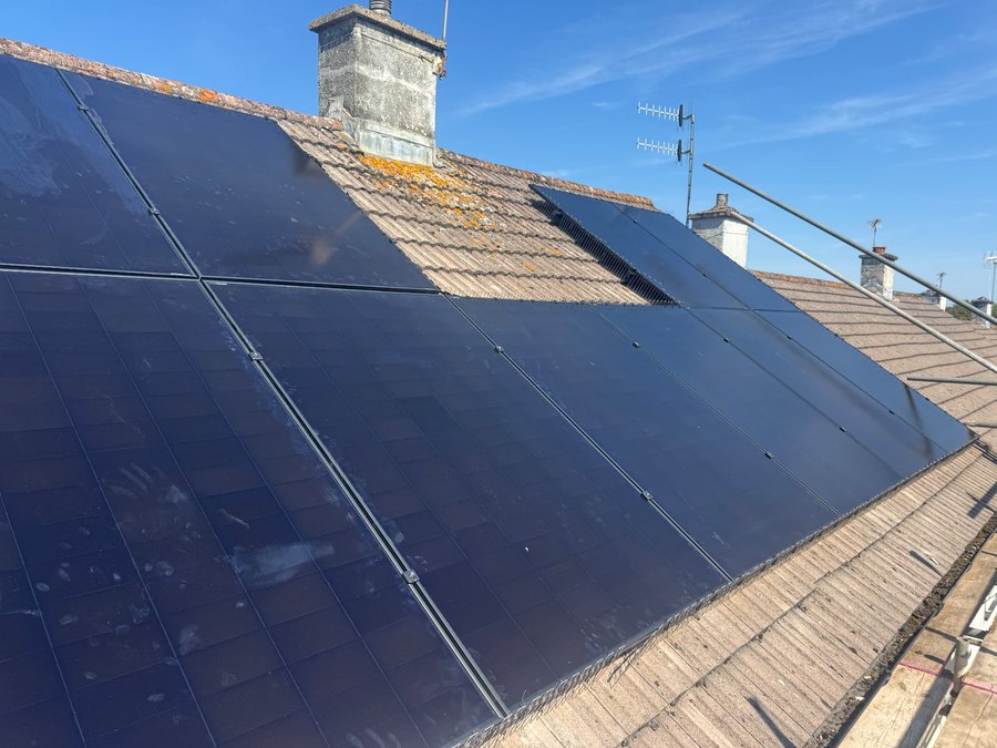 All-black solar panel array on a tiled pitched roof