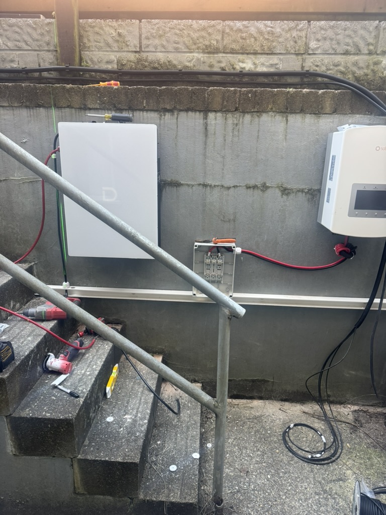 Domestic battery and Solis inverter installation in progress with cable work and an open enclosure