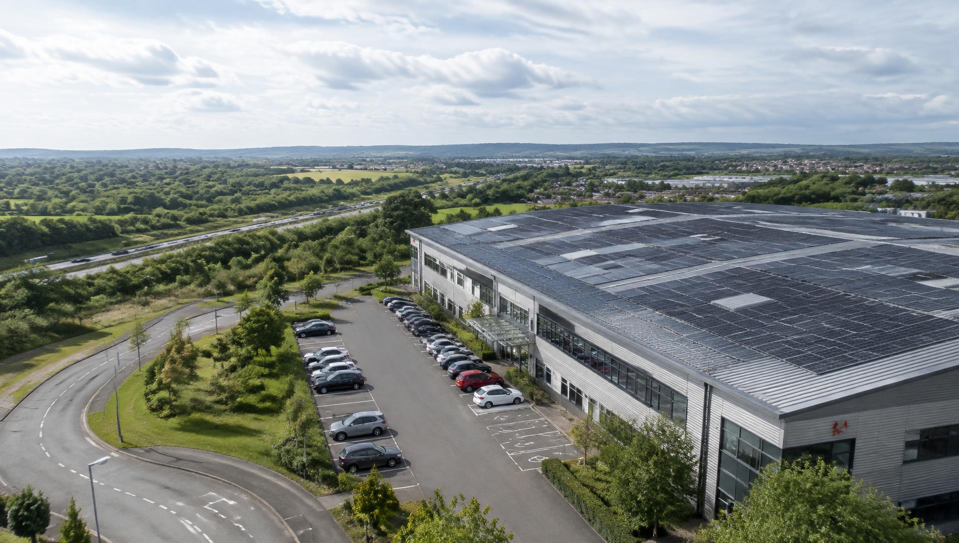 Commercial warehouse with a large roof covered in solar panels